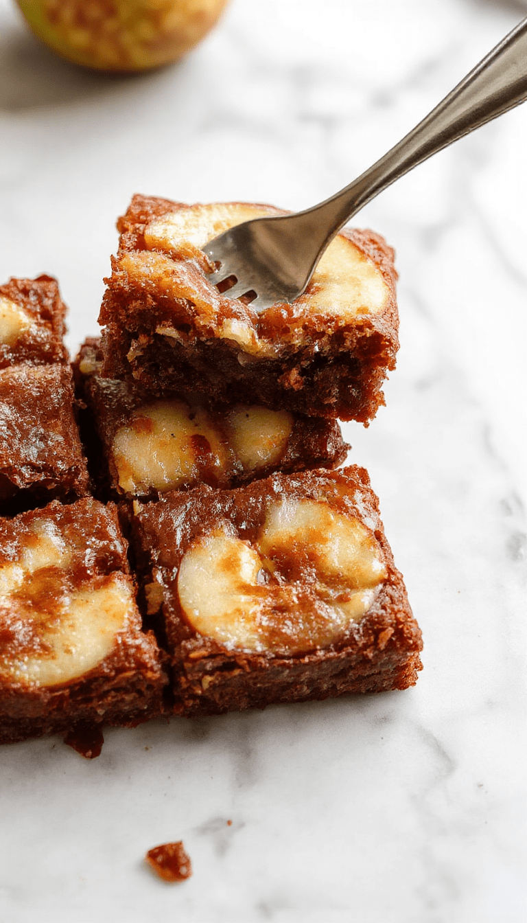 A close-up of a freshly baked apple brownies dessert on a rustic wooden table. The brownies are golden brown with chunks of tender apple visible on top, drizzled with caramel sauce. The presentation is inviting, with a dusting of powdered sugar and a sprig of cinnamon for garnish, styled with a fall-themed background featuring cozy elements and seasonal decor.